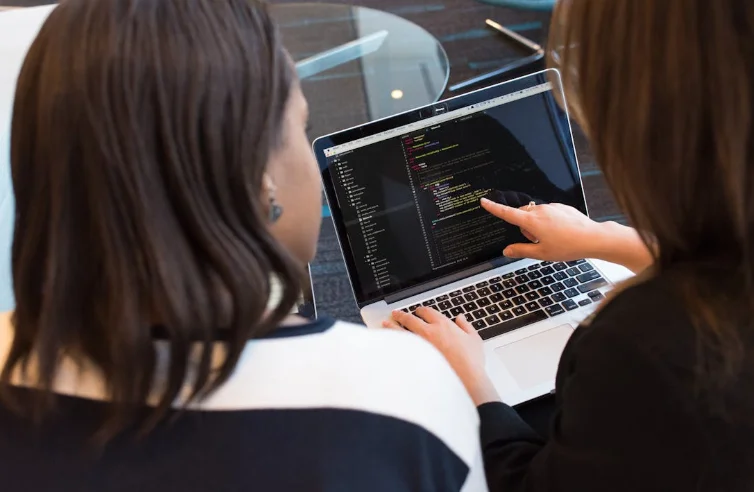 2 Woman Looking at a Laptop Screen