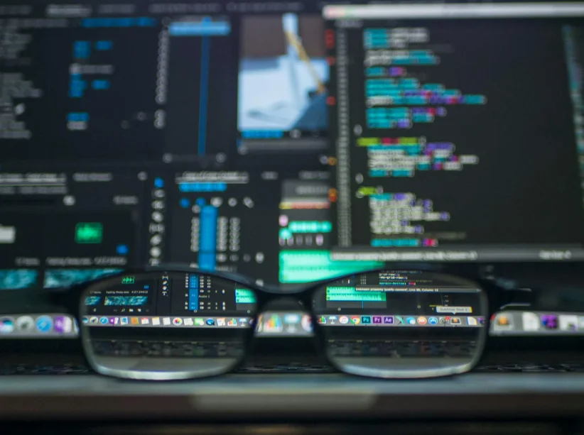 Close Up of Glasses Against a Background of Computer Code