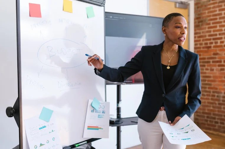 African American Woman Standing in Front of a Whiteboard