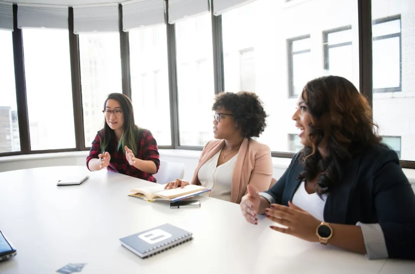 Group of Women Sitting at a Large Conference Table