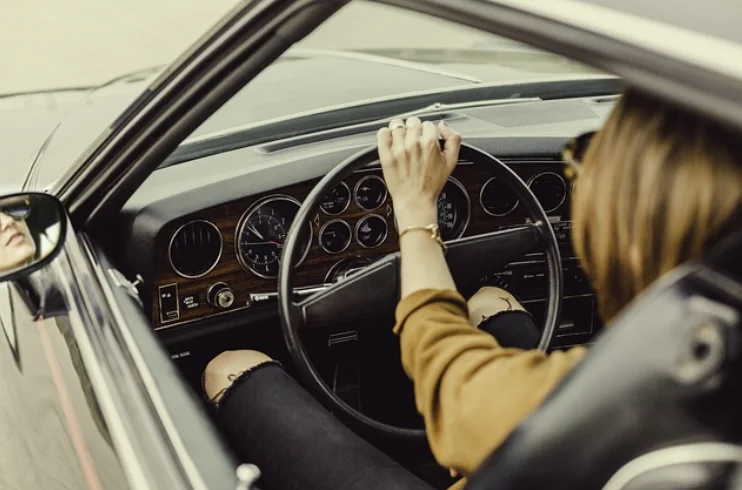 Woman Sitting in the Drivers Seat of a Car