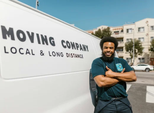 African American Man Standing Next to a Moving Truck
