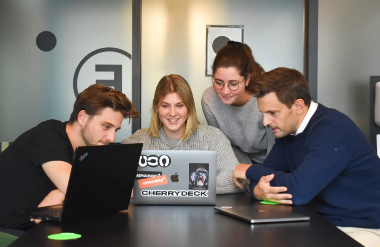 2 Female and 2 Male Millenials Looking at a Laptop Screen