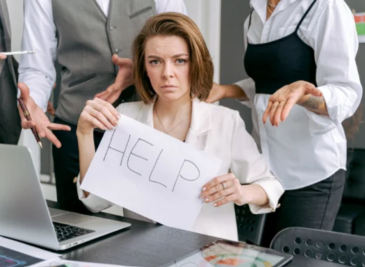 Businesswoman Holding a Handwritten Help Sign